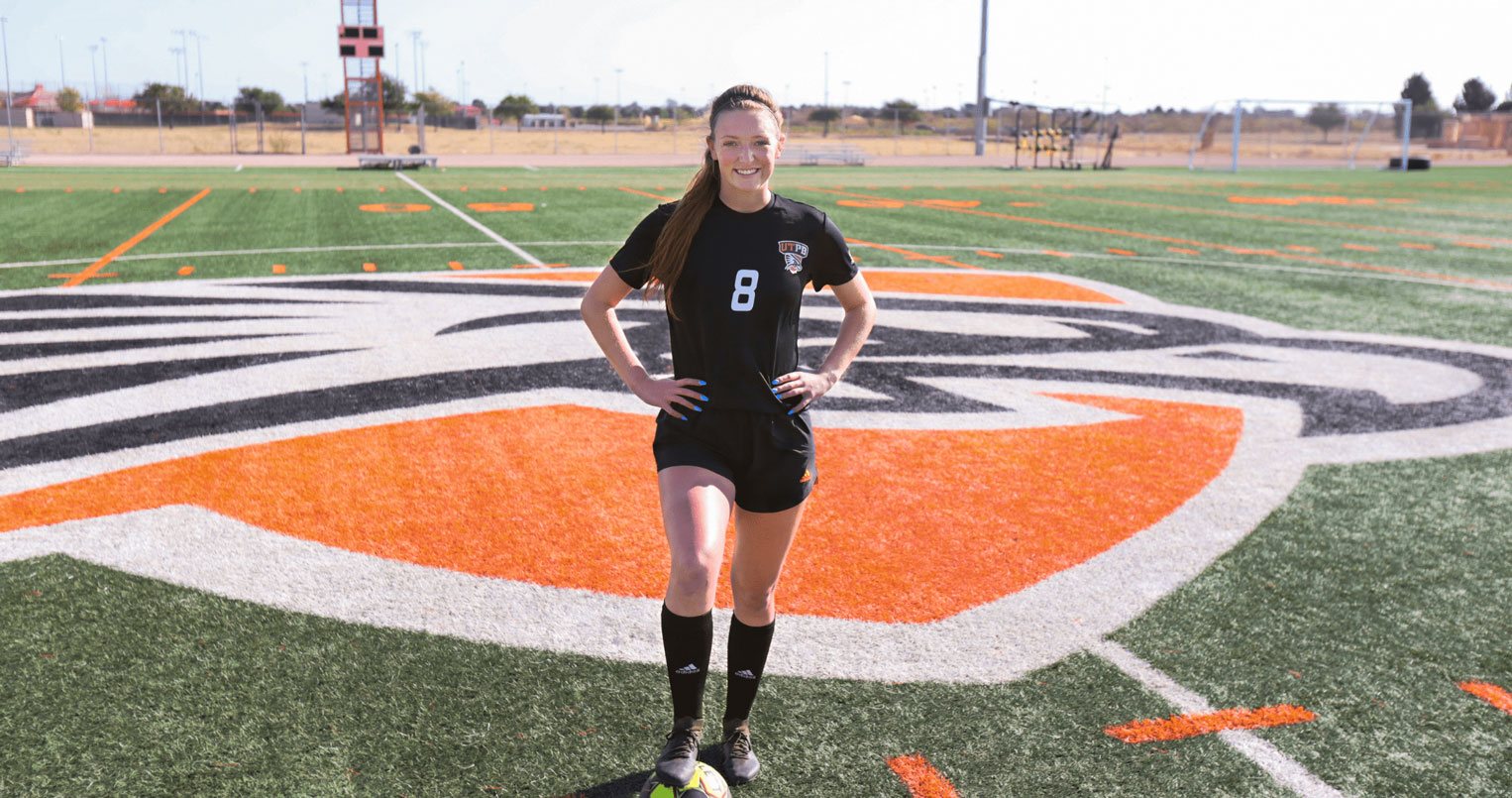Soccer player on field smiling