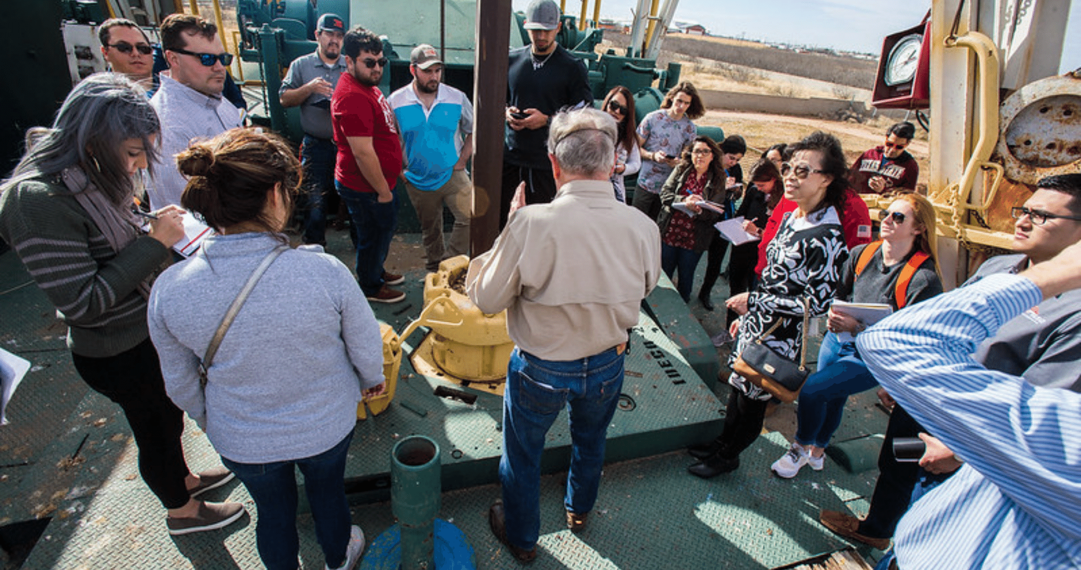 professors teaching students on pump jack