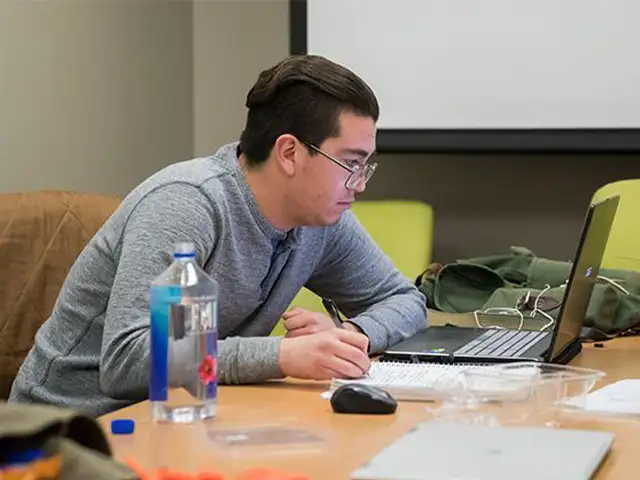 student at his laptop working 