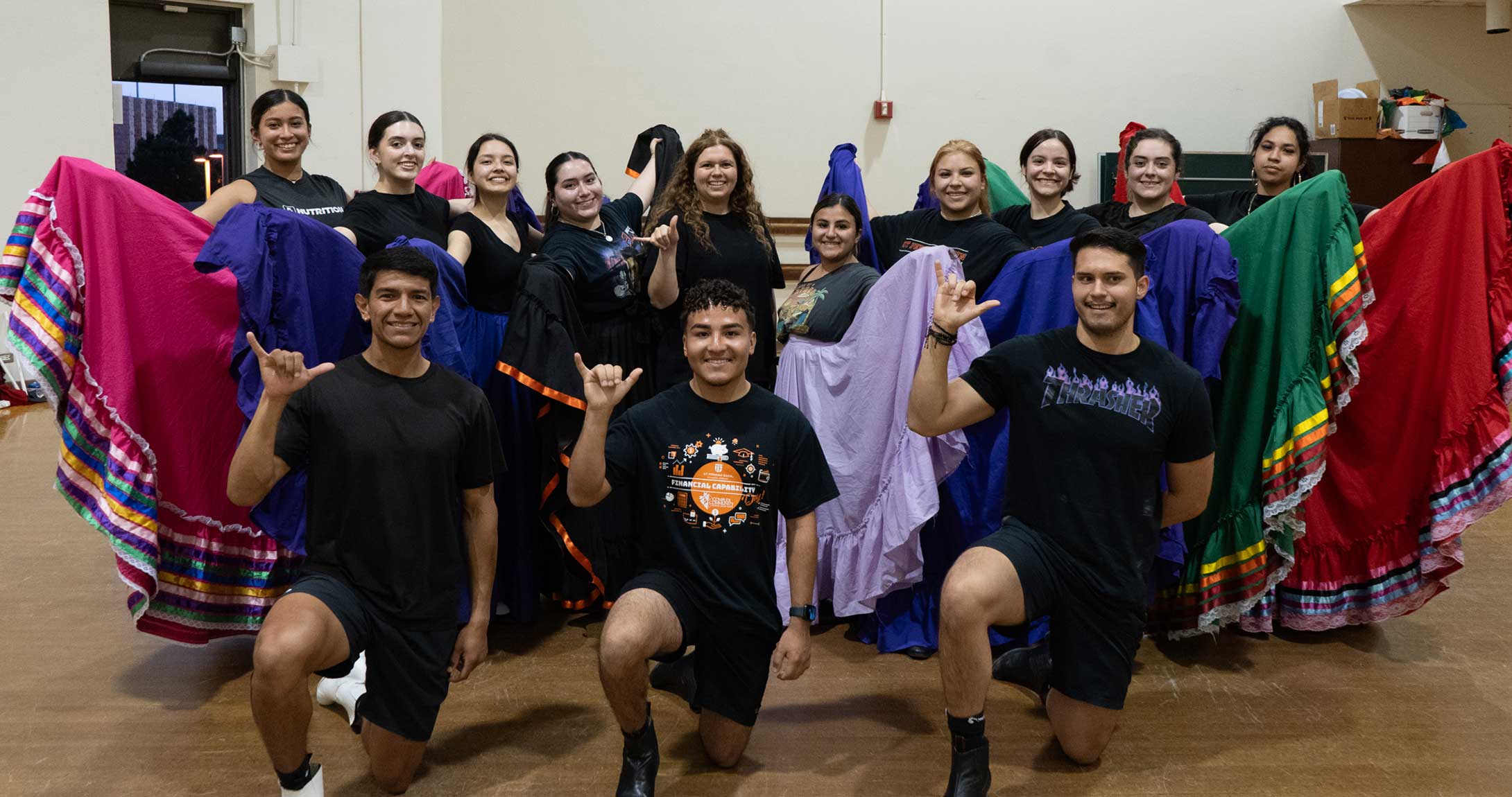 The ballet folklorico group smiles together 