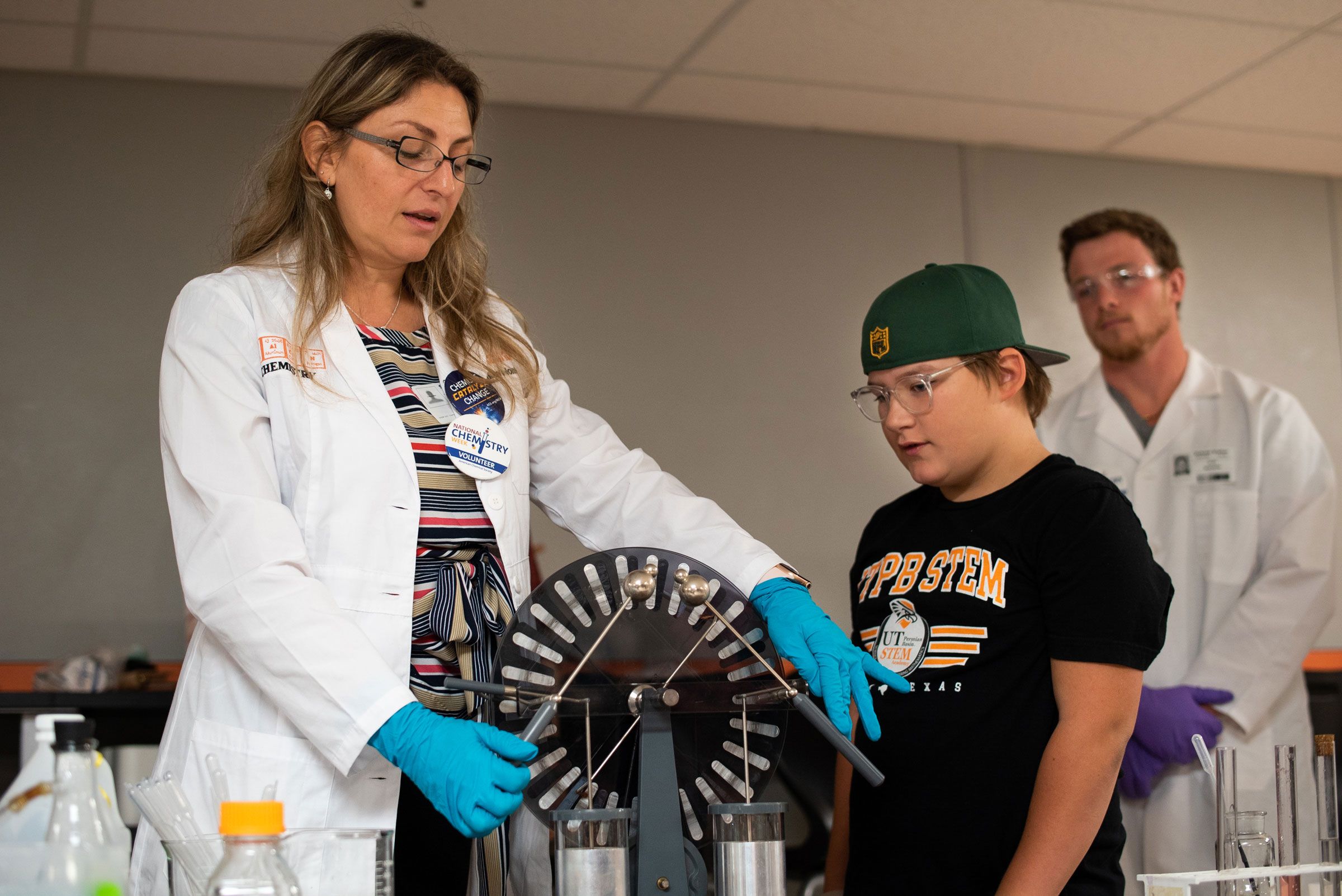 Milka Montes performing a chemistry experiment with elementary student