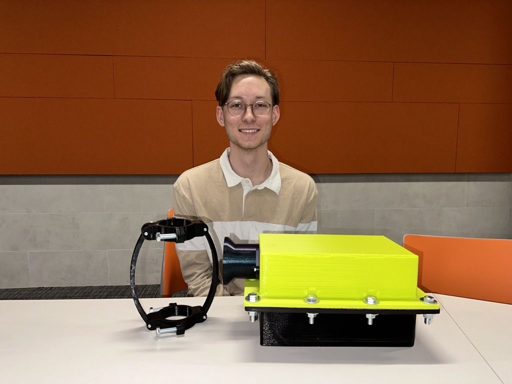  Gerardo Mendoza displaying a filter he designed that will absorb CO2