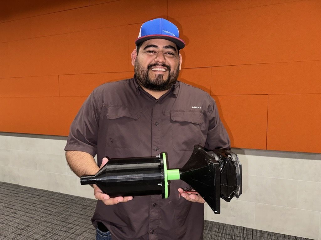 Tye Sikes holding the baffled box he created
