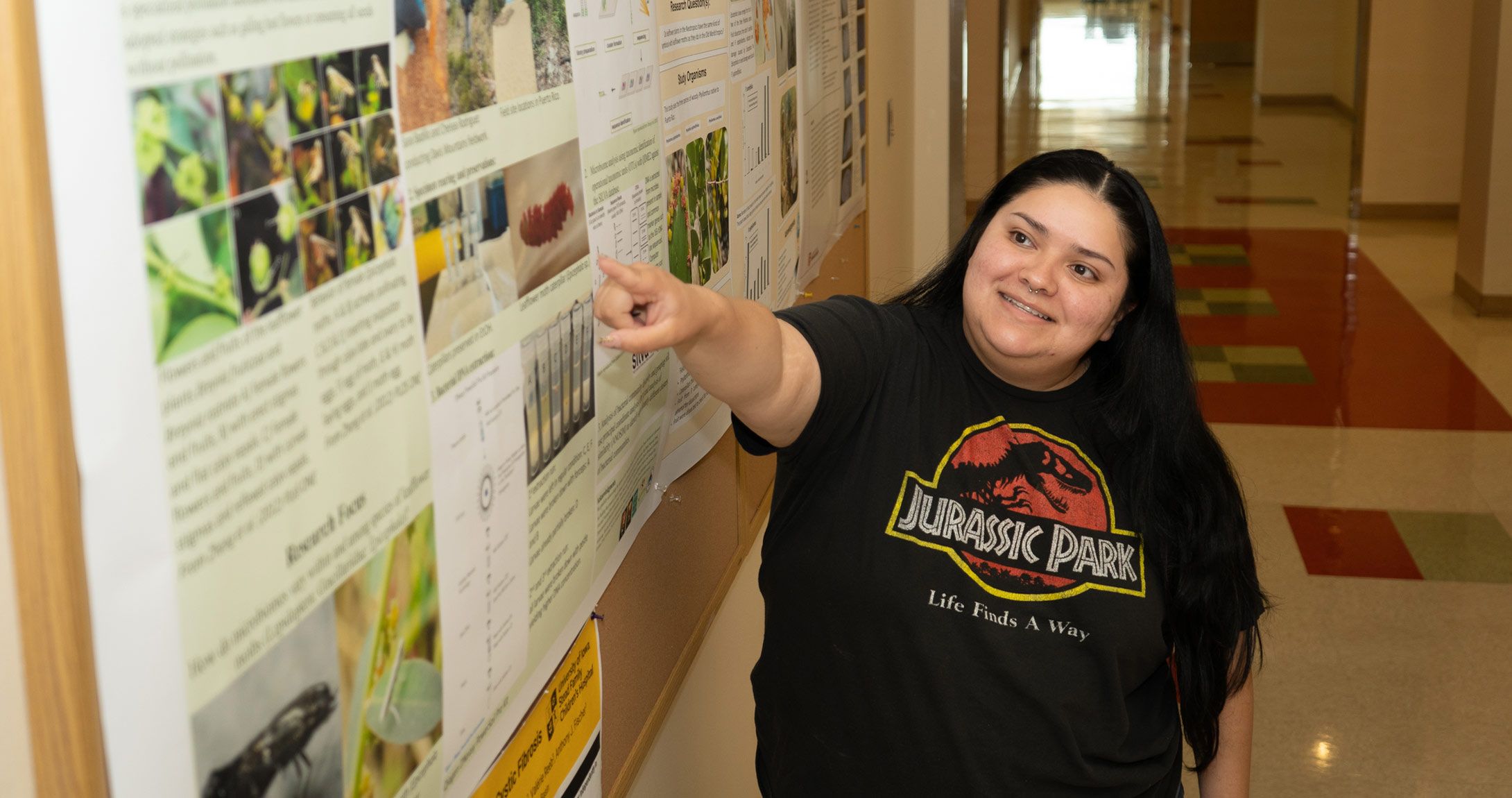 Sarai Badillo pointing at school project 