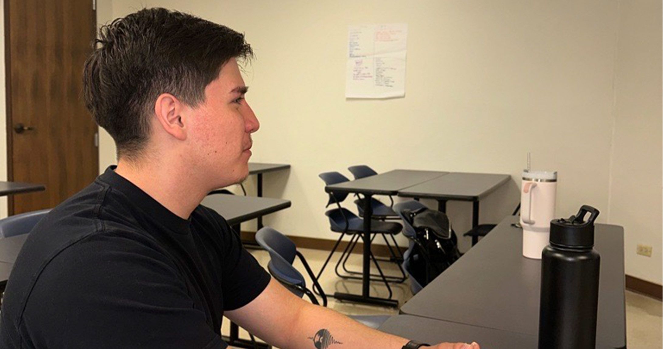 Ethan Flores sitting at desk 