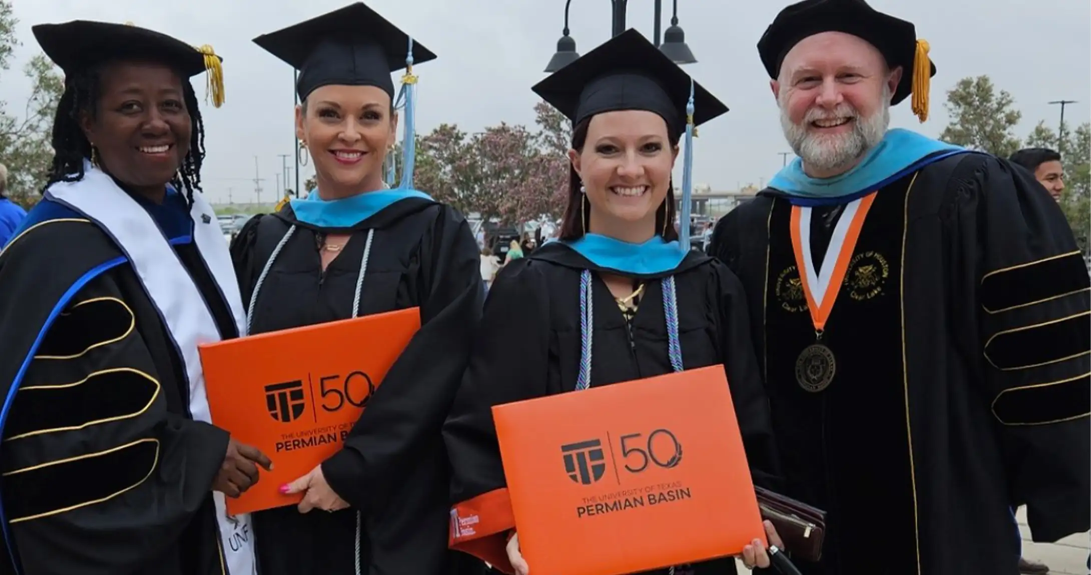 Masters in Educational Leadership students posing at graduation 