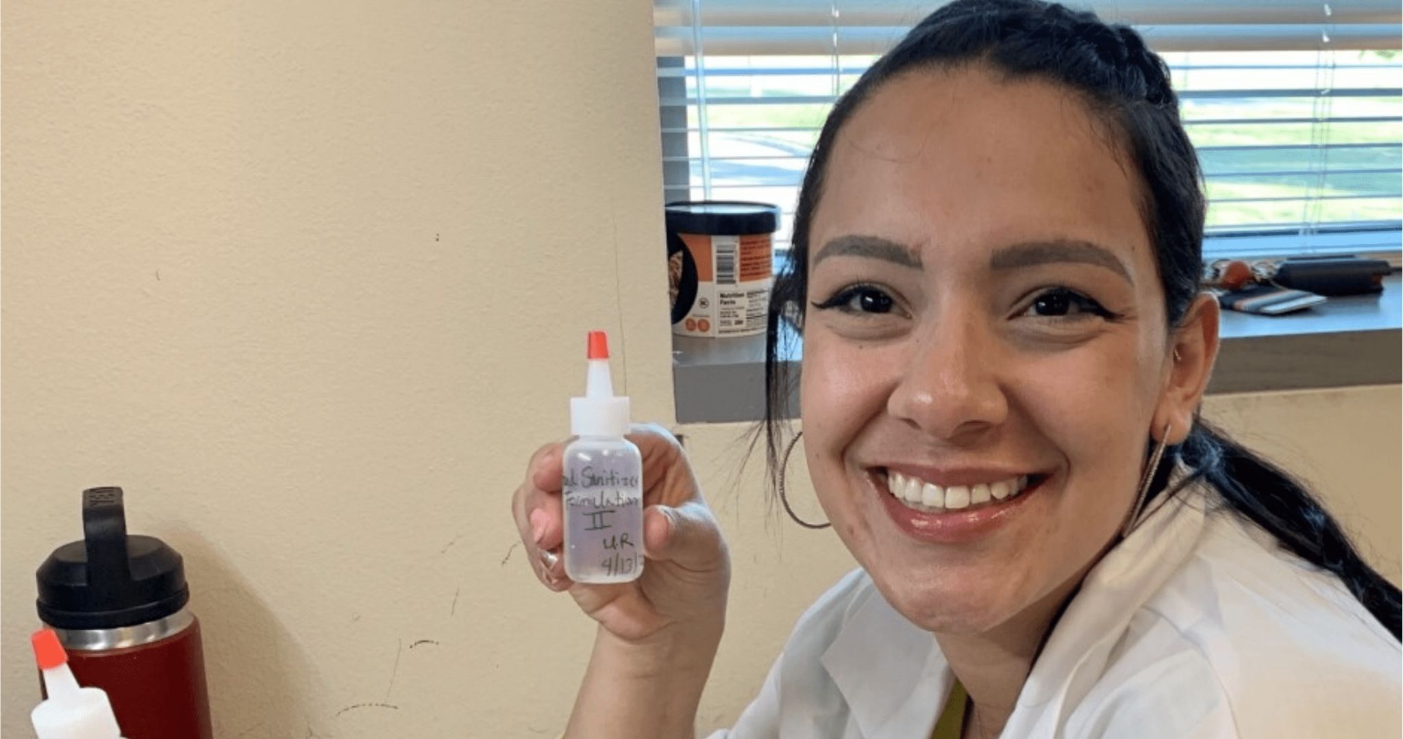 学生 researcher, Mikayla Rodriguez holding hand sanitizer 