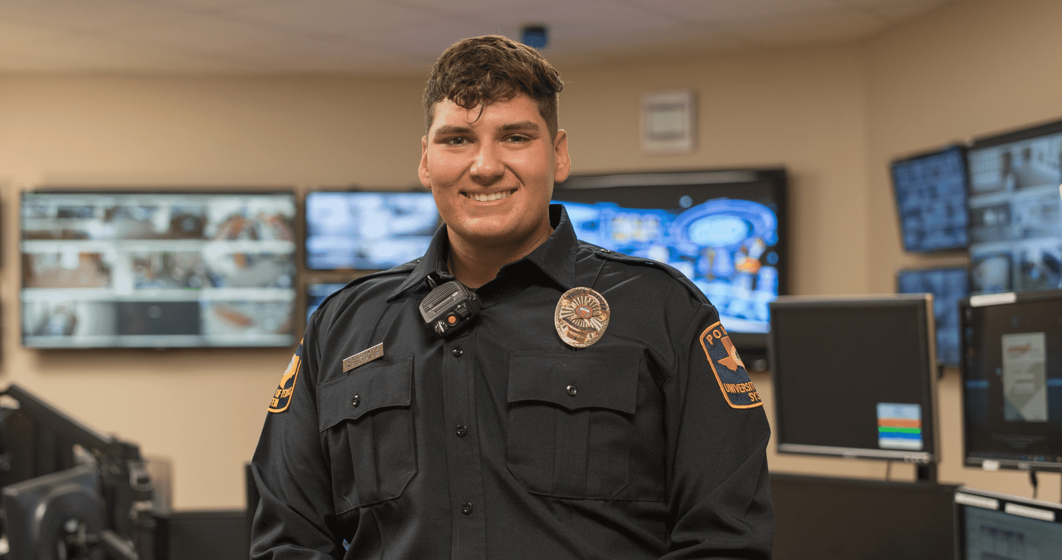 Officer Harris smiling for camera in dispatch center
