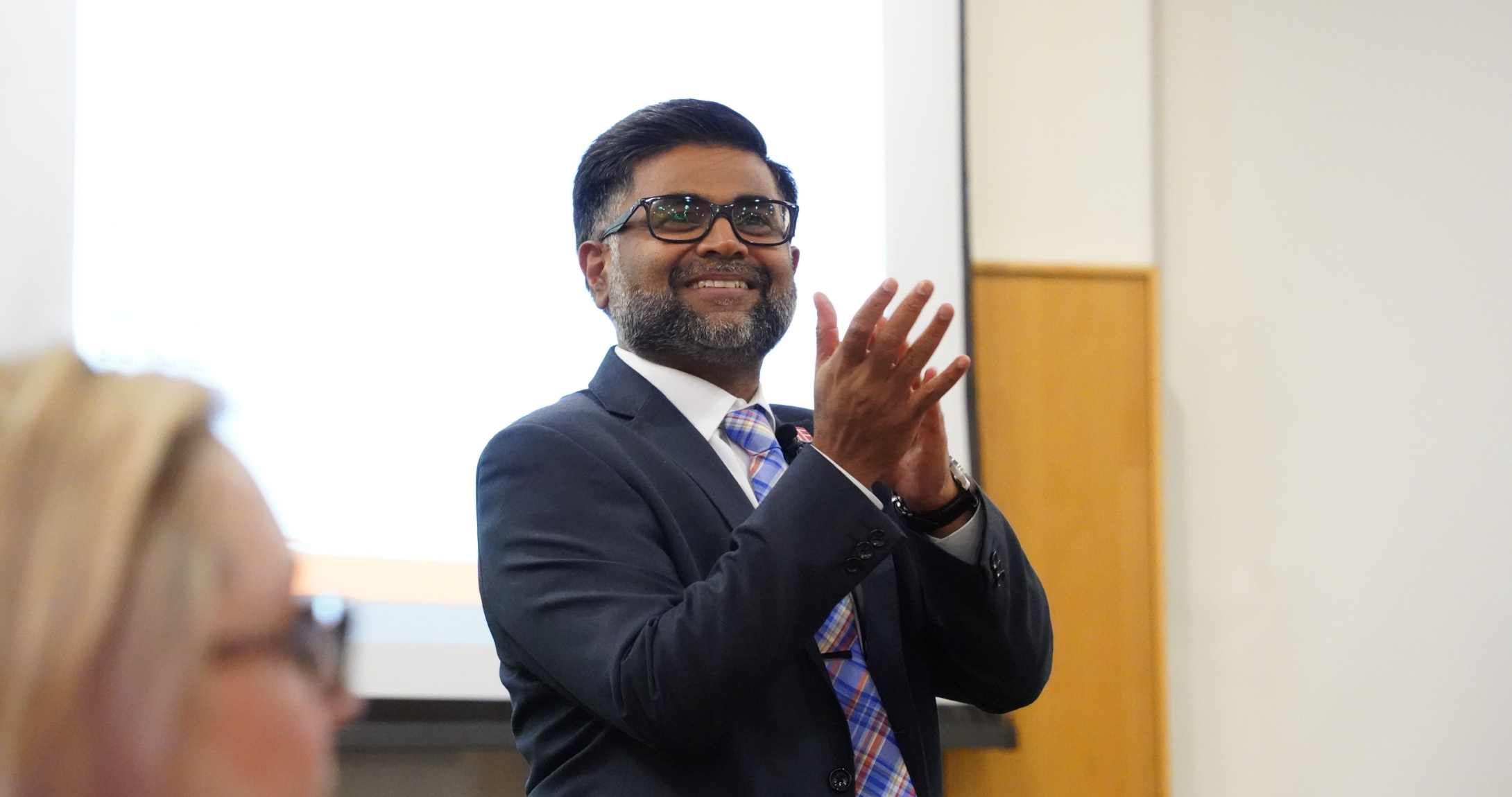 Raj Dakshinamurthy smiling and clapping