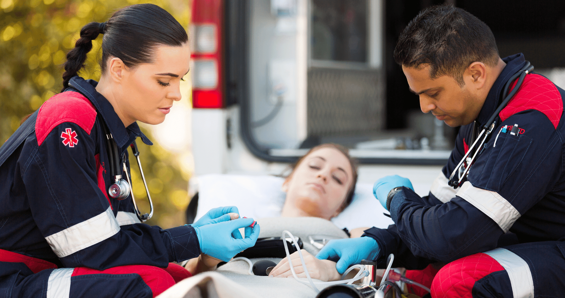 two EMT's treating patient in ambulance 