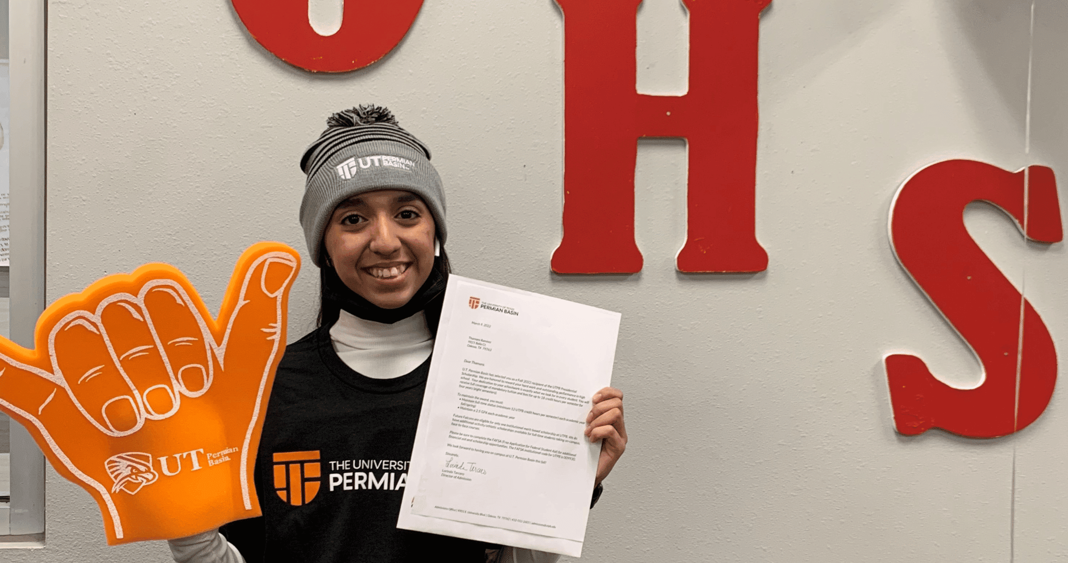 student posing with acceptance letter